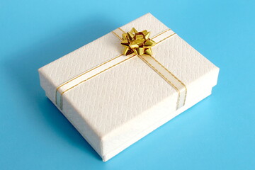 A small gift box lies on a blue background.