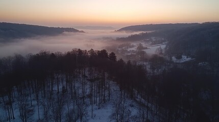 Obraz premium Winter Sunrise Over Foggy Valley and Snow Covered Woods
