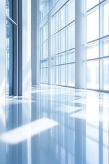 Obraz premium Modern office interior design with large windows and polished floors, bright natural light illuminating spacious hallway in contemporary architecture.