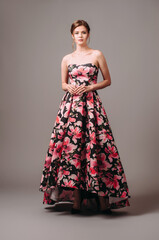 Attractive brunette young lady in studio. Women's occasion look. Bandeau corset structured skirt...