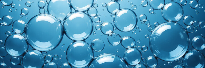 Transparent water bubbles floating in blue liquid
