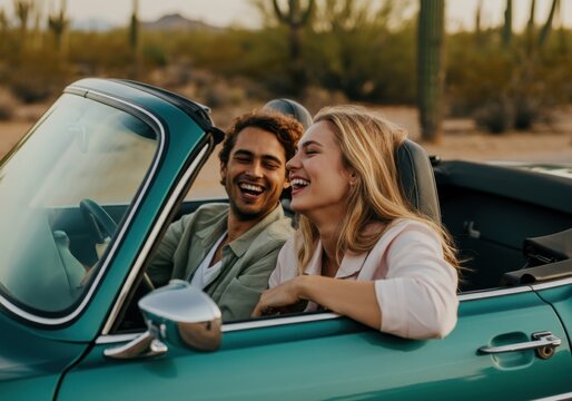 Young couple laughing in convertible desert drive
