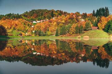 Amber and Crimson Foliage Reflecting in the Glassy Autumn Lake