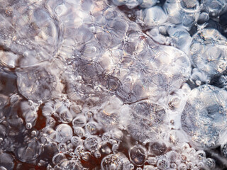Ice surface, texture with cracks, bubbles and frozen leaves for computer graphics, texturing, compositing or as a background