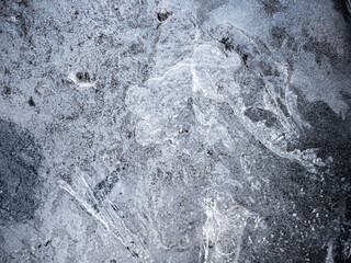 Ice surface, texture with cracks, bubbles and frozen leaves for computer graphics, texturing, compositing or as a background