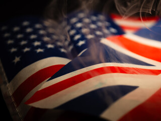 American flag and British Union Jack flag smoke selective focus