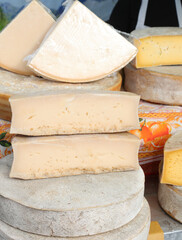 forms of aged cheese for sale at the local market stall