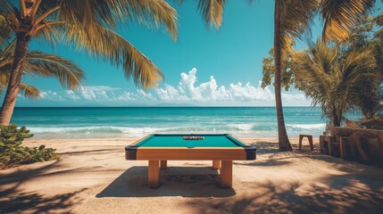 Pool table on a beautiful beach surrounded by palm trees and ocean