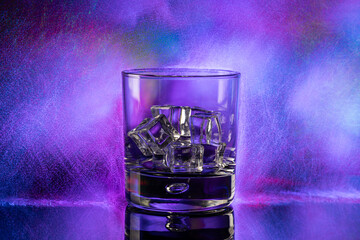 whiskey Glass of ice  on purple background.