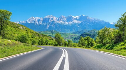 Scenic Drive Through Verdant Landscape with Majestic Mountain Range Under Clear Blue Sky on Sunny Day