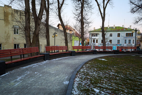 Drogobith, Ukraine, - February  17, 2025: A pedestrian path in the park in the center of Drohobych with many benches for rest. A place for walks and relaxation.