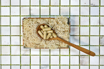 multicolored tablet on white background of checkered tiles top view