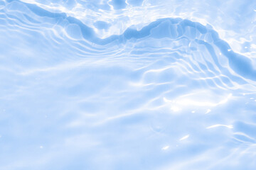 The clear water surface displays gentle ripples and reflections of light, capturing the essence of serenity and freshness on a sunny day.