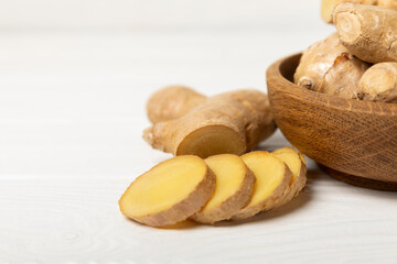 Fresh ginger on wooden background. Dry ginger. Sliced ​​ginger with honey and lemon. Ginger root. Traditional alternative medicine, healing tea for immunity. Seasoning and spices concept. Copy space.