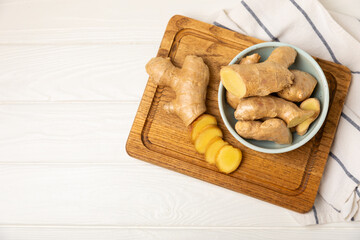 Fresh ginger on wooden background. Dry ginger. Sliced ​​ginger with honey and lemon. Ginger...