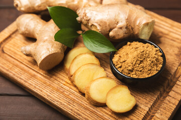 Fresh ginger on wooden background. Dry ginger. Sliced ​​ginger with honey and lemon. Ginger root. Traditional alternative medicine, healing tea for immunity. Seasoning and spices concept. Copy space.