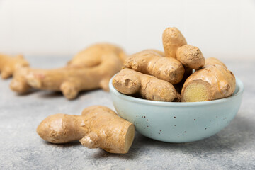 Fresh ginger on wooden background. Dry ginger. Sliced ​​ginger with honey and lemon. Ginger...