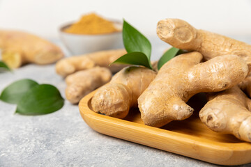 Fresh ginger on wooden background. Dry ginger. Sliced ​​ginger with honey and lemon. Ginger...