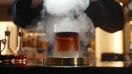 Cropped bartender serving mist smoky classical mixing whiskey cocktail fantastic presentation, recommending special welcome tasty creative advertisement drink at beverage counter bar luxury. Vinosity.
