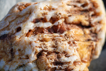 Textured quartz stone with orange iron inclusions on macro