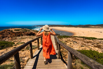 Sightseeing of Algarve coast in Portugal. Happy middle-aged woman tourist enjoying vacations over...
