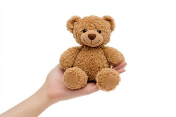 Fototapeta premium A soft, brown teddy bear being held gently in a caring hand against a white background isolated on transparent background