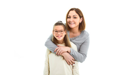 Portrait of disabled girl smiling at camera with her mother over white background