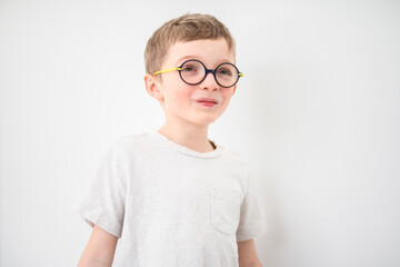 portrait of handsome little boy in glasses isolated on gray background