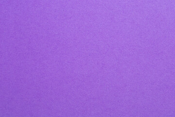 A purple background with a white dot in the middle, textured origami paper backdrop