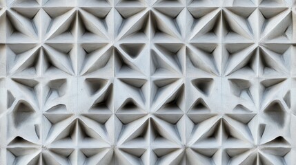 Textured pattern of white geometric shapes highlighting three-dimensional pyramid designs, perfect for modern architecture, backgrounds, and creative projects.