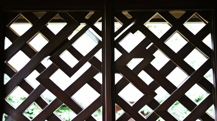 Intricate geometric lattice design of an open wooden door showcasing natural light filtering through, captivating interplay of shadow and structure