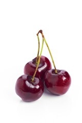 Fresh cherries on a white background showcasing vibrant color and healthy appeal