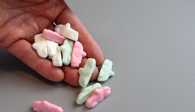 Hand with Swedish candy cars. Close up and isolated.