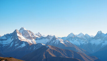 Fototapeta premium Mountain landscape with snow-capped peaks under blue sky