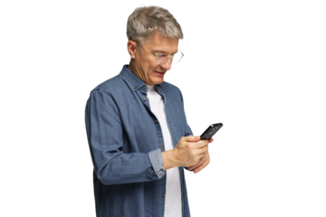Senior man in casual outfit using smartphone while standing indoors in well-lit environment