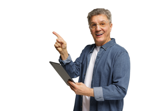 Senior man smiling and pointing while holding a tablet against a plain background