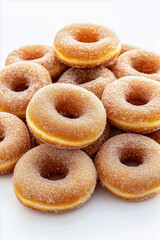 A pile of donuts with powdered sugar on top