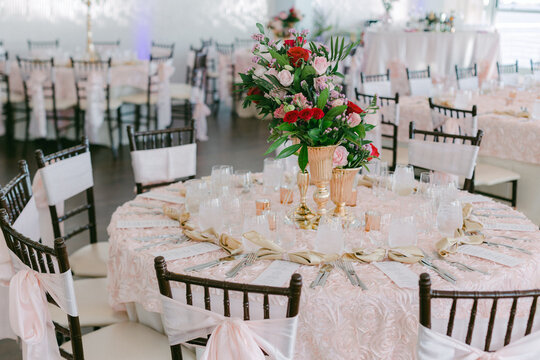 Elegant table setting with floral centerpiece at a celebration venue during a daytime event