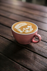 closeup of latte coffee cup on wooden table at coffee shop day time	