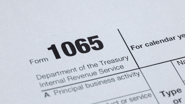 Close-up of a Form 1065 tax document, used for reporting partnership income to the Treasury. Filing and compliance concepts visualized.