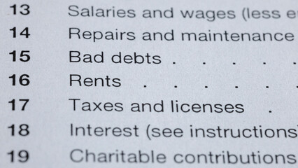 Obraz premium Tax form section showing lines for salaries, repairs, bad debts, rents, taxes, interest, and charitable contributions. Financial reporting and record-keeping are essential.
