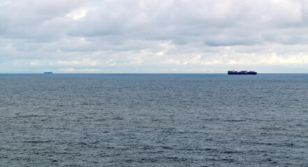 Obraz premium Cargo ships in the Pacific in the morning hours seen from a passing cruise ship.