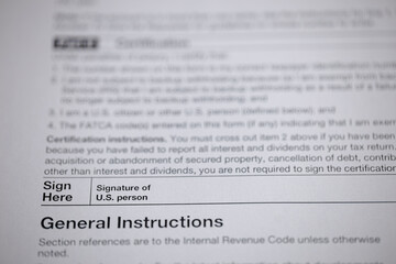 Fototapeta premium Sign Here: U.S. Person Form - Instructions for certification and general guidance on IRS codes and reporting requirements.