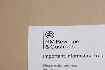 Official tax document with a crown logo, detailing revenue and customs information. Notice on a desk. Compliance and government notification