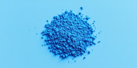 Heap of blue powder on blue background. For pigment, cosmetics, industry, or art use