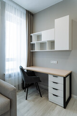 The room is equipped with a fully functional desk and a very comfortable chair, which together create an inviting and conducive space perfect for writing, working, or studying and focusing