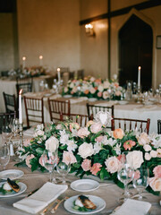 Elegant wedding reception setup featuring floral arrangements and candlelit tables in a historic venue
