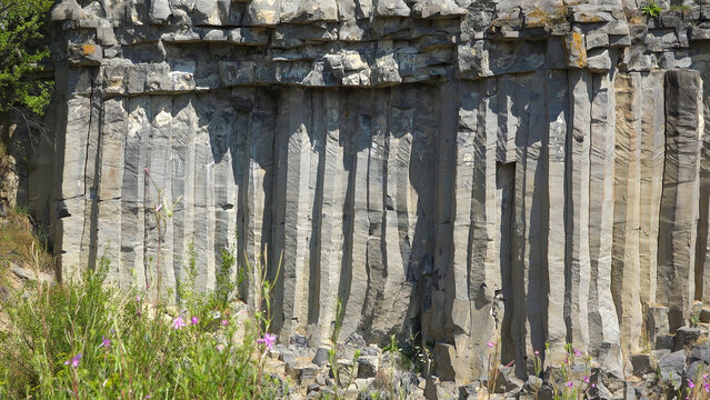 The volcanic basalt columns rock wall of Racos in Romania