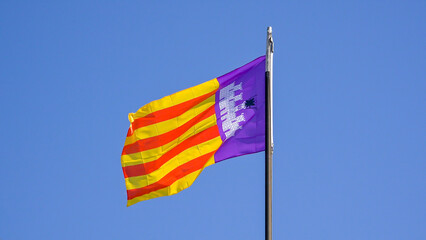 Mallorca flag waving in summer breeze on clear blue sky
