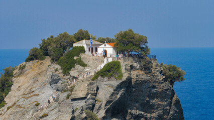 People climbing the stairs of Agios Ioannis church on top of the cliff